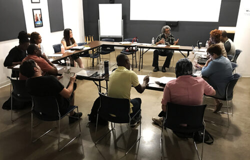 David Grant teaching a class of students sitting at tables