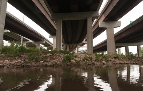 A creek that passes under several highway overpasses